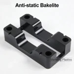 A stack of black anti-static bakelite sheets for electronics manufacturing.
