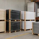 Heavy-duty palletized ABS and PP plastic sheets wrapped with protective PE film and corner guards inside Viethung Plastics packaging area in Vietnam, prepared for ocean container shipping.